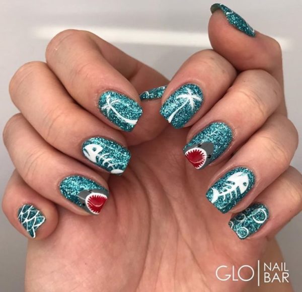 Aqua glitter creates the perfect base for this marine mani