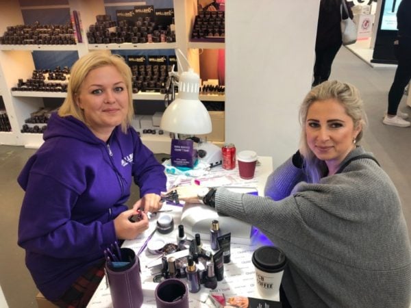 October cover star, Neringa Alsauskiene, tends to the nails of Brillbird's Liliya Moss