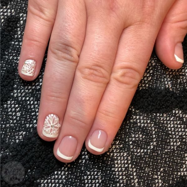 A classic French manicure can be upgraded with Swarovski crystals/ embellishments & hand painted or stamped designs.