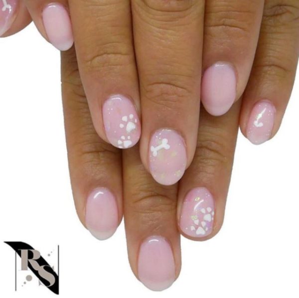 This loveable pastel set by @raw_sugar_nails is decorated with paw prints and bones