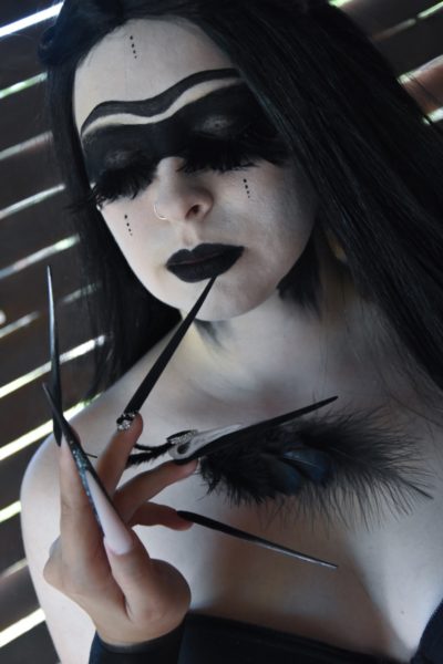 Evelin Nagy
"I'm grateful for this opportunity, it was pretty exciting, and I could finally get out of my comfort-zone. My poster is about all of my life. Dominating my favorite color, black, black & of course black. Crows and viking culture are playing a huge role in my life. The black make-up, the skull and feathers - dark as my personality. In my opinion Stiletto is one of the most beautiful extreme nail form: Gracious, wild and wonderful at the same time. The nails are acrylgel and gel nails. The skull are made from acrylic powder, and painted with painting gels. In the thumbnail I sculpted in tiny treasures in the french part. For a little extra, I used feathers and rhinestones as decoration."