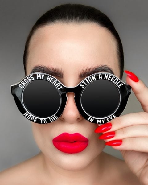 Delia Turville
"My entry represents me as a sassy, bold and honest person with old fashioned values. The decorative text on the sunglasses is an old fashioned saying about telling the truth. "Cross my heart and hope to die, stick a needle in my eye" I am always true to myself, honest to those around me and create my work with integrity. The style of the photograph is my typical bold style. I love a classic red lip and matching red almond nails. I wanted to create a fuss free fashionable image encompassing red and monochrome as this is my favourite colour palette. This entry represents me to a Tee!"