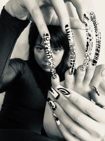 Sarah Murray
"I’m kind of quirky and edgy, but I’m still figuring out who and what I want to be. The hands and toes being joined together gives the sense of feeling trapped and compromised. Something which I am trying to break free of through doing nails. In my free time I train contortion and hand balancing for the circus and shown this through the poses I’ve done.The nail style is inspired by Hattie Stewart as I love really bold and graphic images."