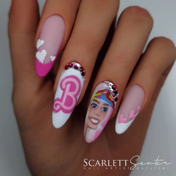 This design by award-winning nail pro, @scarlett_senternailartist, takes inspiration from Margot Robbie's character in the live-action Barbie movie.
