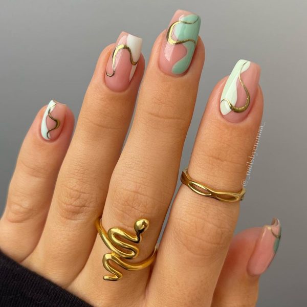 This classy nail style by @_nailsbyemmaa_ features swirly touches of green and gold. 