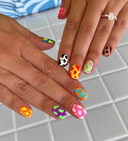 @peachinails adds a rainbow twist to cow print nails. 