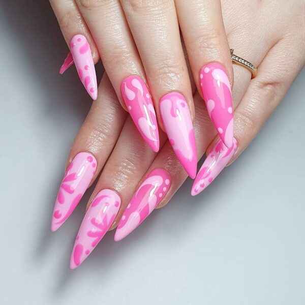 Norwich nail tech, @pineapplegelnailss, goes abstract with the Barbiecore trend on Nail Order Long Stiletto Tips.
