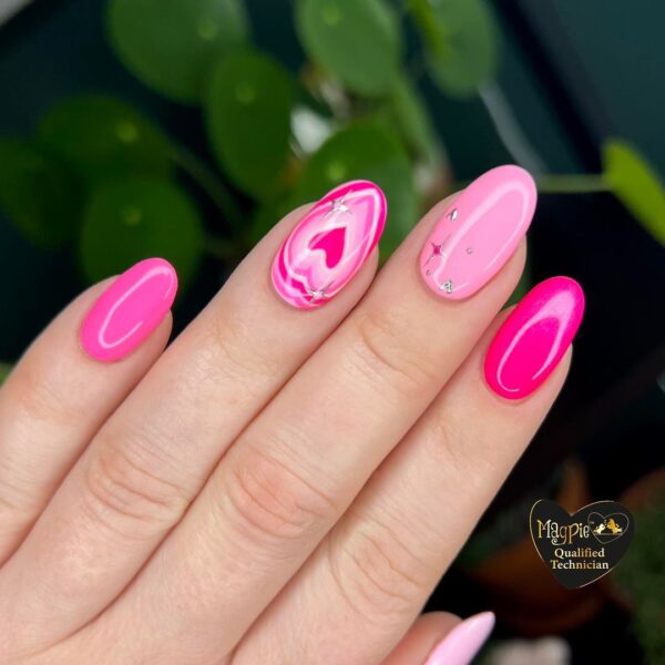 Emily Langford of Lincolnshire home salon, @studio.one.o.nine, fashions this tonal pink design, featuring a detailed heart feature nail.