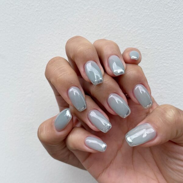 @dawonnail depicts two nail trends: chrome tips over a bluey grey syrup base.