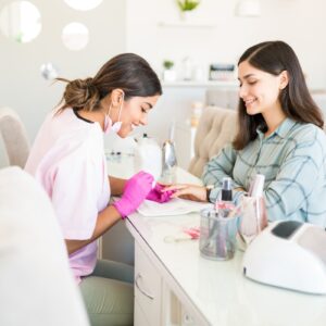 Happy nail technician & salon client